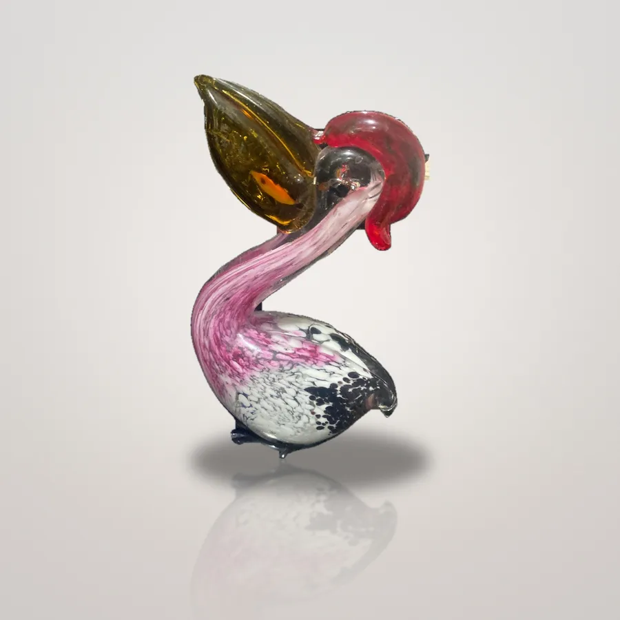 Glass pelican holding a fish in its bill